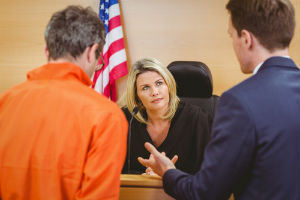 lawyer and his client speaking with judge at her bench