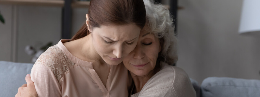 mother and daughter sad after death in family