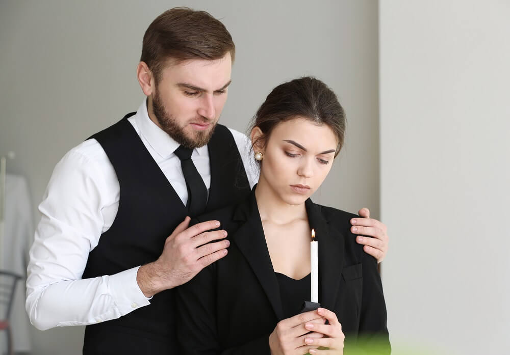 Couple mourning over the death of their mother.